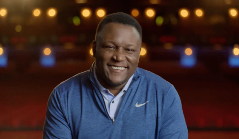 Barry Sanders smiling during an event, highlighting his net worth and NFL legacy