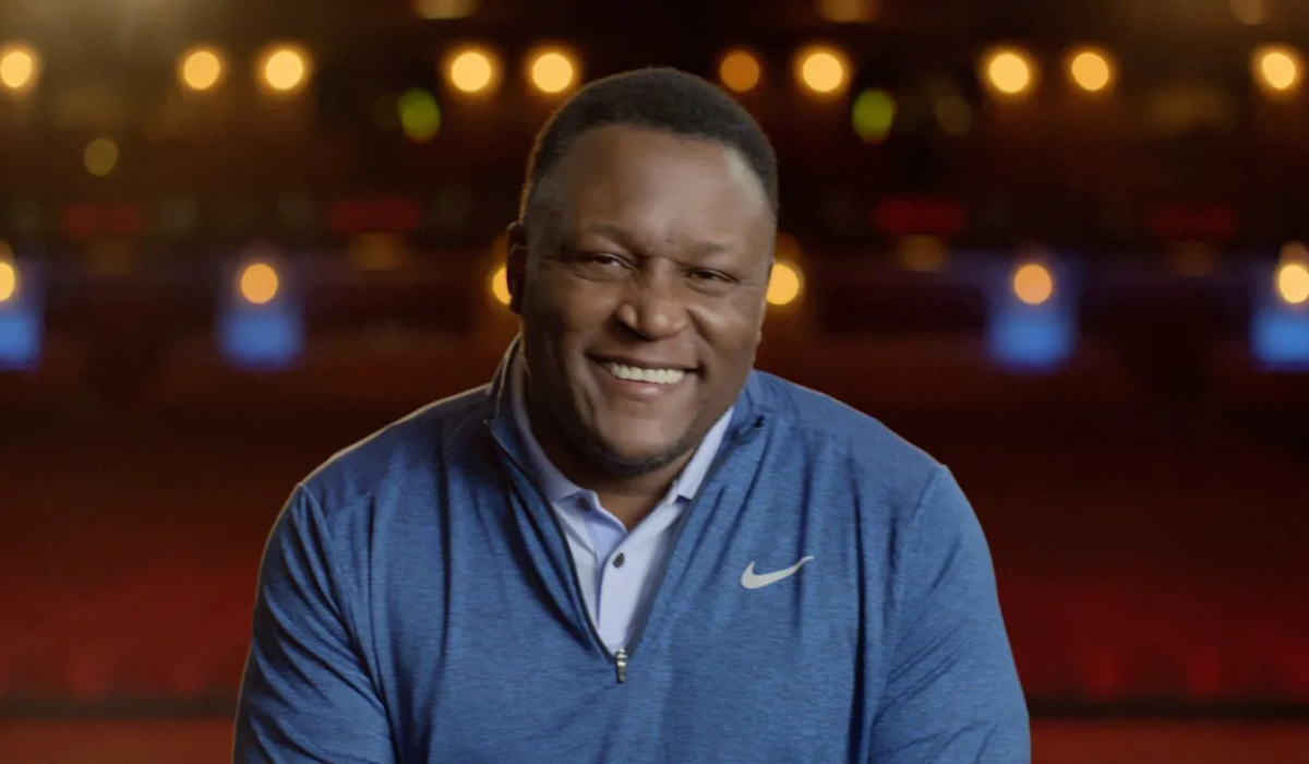Barry Sanders smiling during an event, highlighting his net worth and NFL legacy